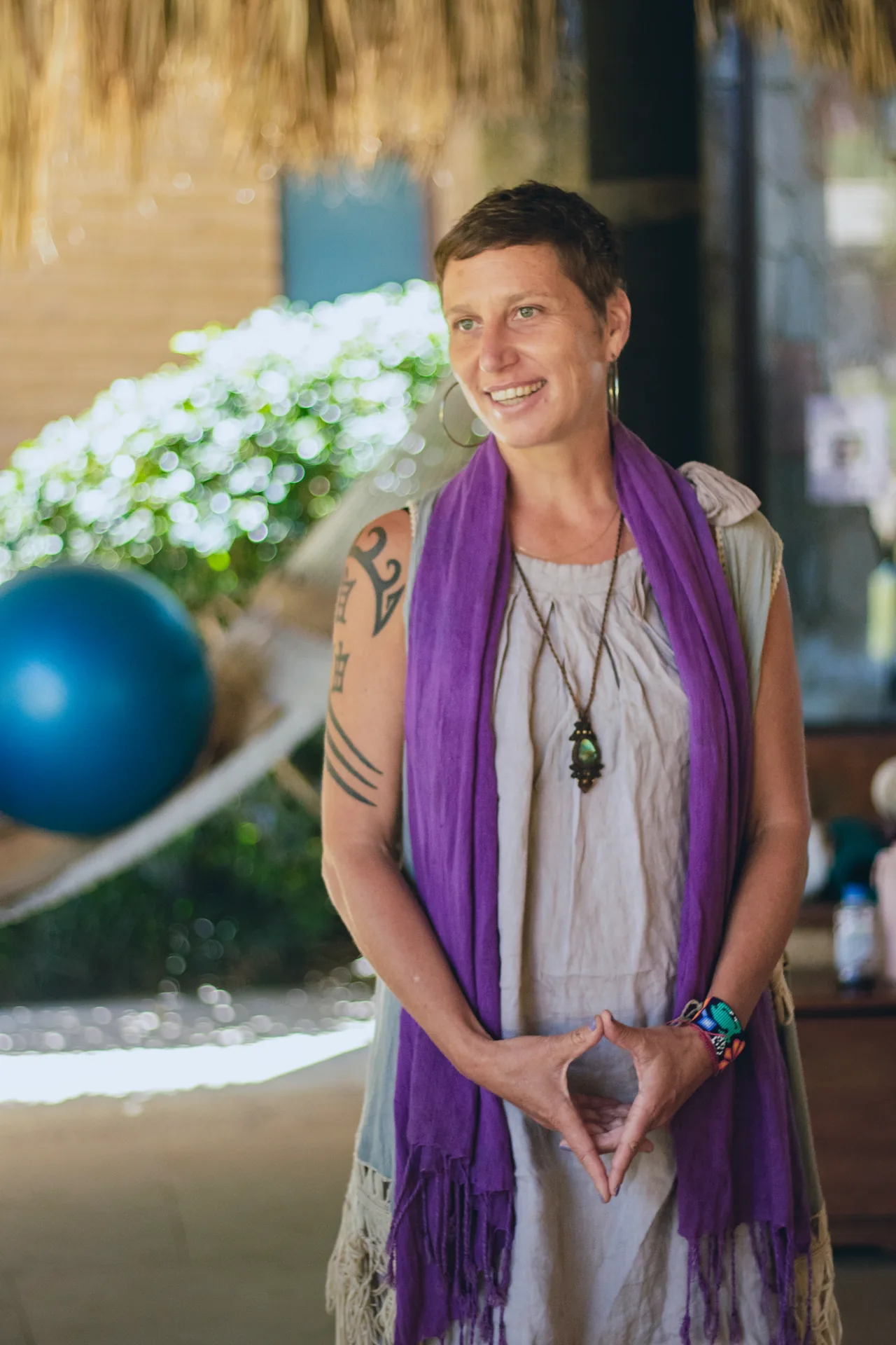 Leila speaking at a gathering in a purple shawl